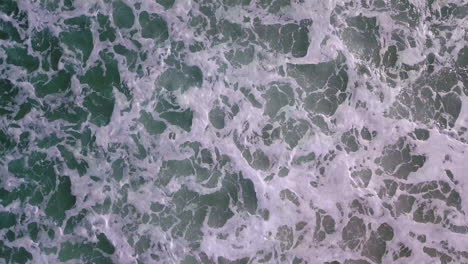 Aerial-footage-of-waves-rolling-into-shore-off-the-coast-of-Southern-California