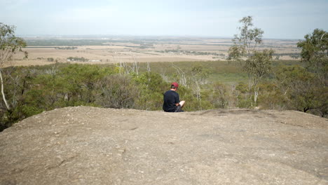 Man-looking-out-from-the-You-Yangs-National-Park,-Victoria-Australia