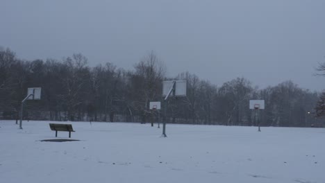 Snow-covered-basketball-court-at-dusk