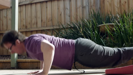 Middle-aged-man-doing-push-ups-in-the-back-yard