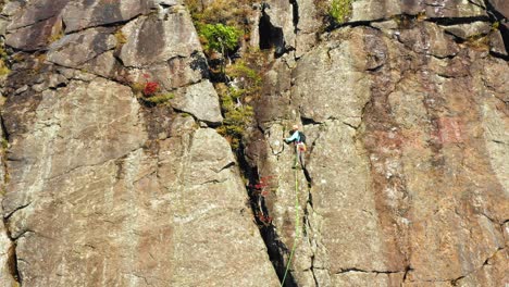 Aerial-footage-Lifting-up-past-a-lone-climber-on-a-cliff-in-Maine