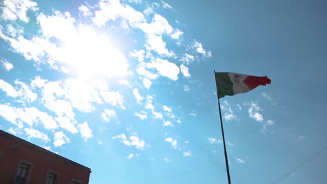 Mexican-flag-waving-in-a-blue-sky