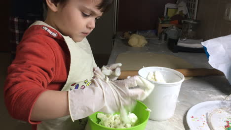 Close-Up-Shot-Of-A-Kid-Crushing-Feta-Cheese-In-A-Bowl