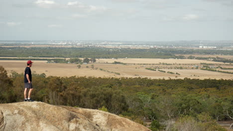 Man-looking-out-from-the-You-Yangs-National-Park,-Victoria-Australia