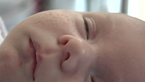 A-close-up-of-a-sleepy-newborn-baby's-face
