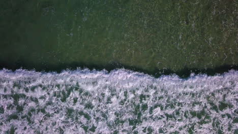 Aerial-footage-of-waves-rolling-into-shore-off-the-coast-of-Southern-California