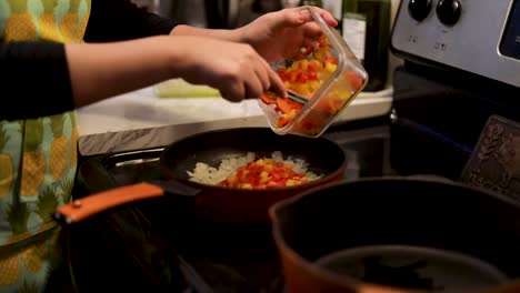Adding-bell-peppers-to-cast-iron-skillet