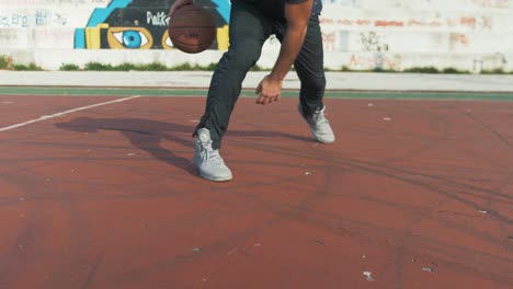 Real-time-dribbling-basket-ball-between-legs-on-outdoor-court
