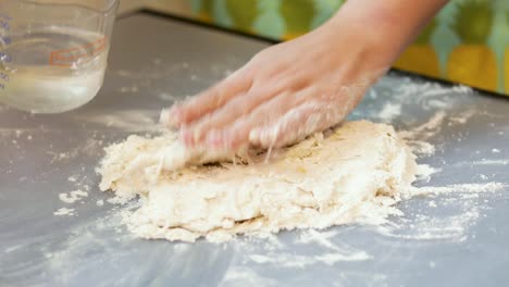 Pouring-water-on-dough