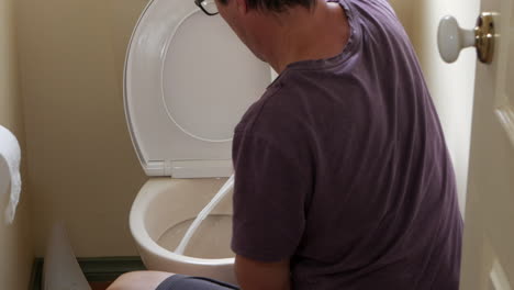 Man-cleaning-household-toilet-bowl