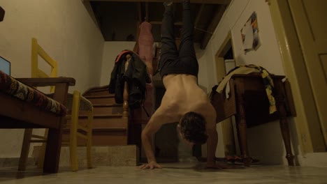 Fit-young-male-handstand-push-up-home-workout-indoors