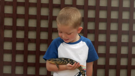 Caucasian-child-holding-a-blue-tongue-lizard