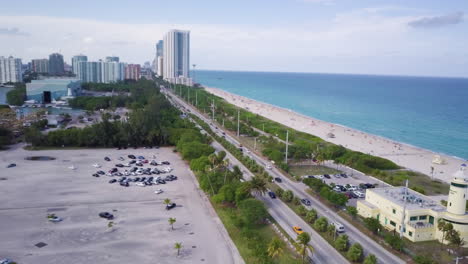 Aerial-Shot-of-Collins-Avenue-Miami-Overlooking-Passing-Cars-and-The-Ocean