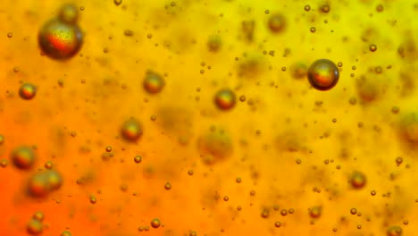 Carbonated-ascending-in-a-glass-with-a-background-that-changes-colors
