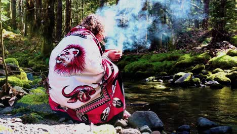 Sangoma---Shaman-woman-at-the-creeks-edge-with-a-burning-bowl,-speaking-with-her-Ancestors