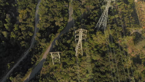 Aerial-Rotation-Around-Power-Lines-on-a-Verdant-Mountain