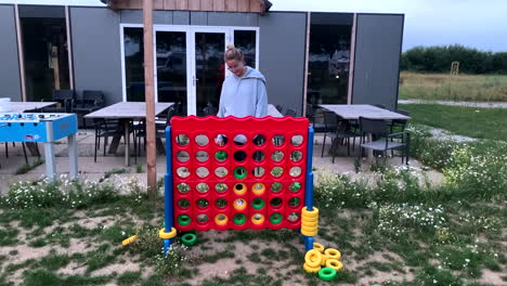 Woman-plays-Connect-Four-outside-in-big-version