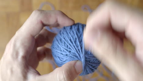 Hand-finishing-winding-ball-of-blue-wool
