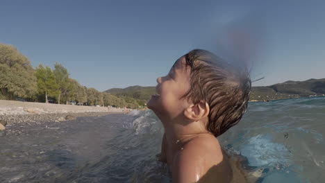 Footage-of-Two-Years-Old-Boy,-Playing-With-Waves-At-Santova-Beach,-Kalamata,-Greece