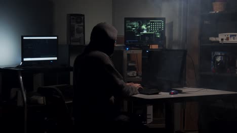 Computer-Hacker-types-in-computer-code-in-a-back-room