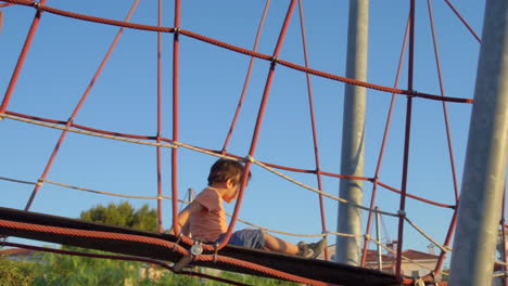 A-kid-walks-on-a-rope-bridge-at-a-park