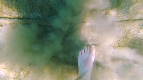 White-Male-Feet-Walk-on-Sand-Bottom-of-Lake-in-Slow-Motion,-Wide-Underwater-Close-Up