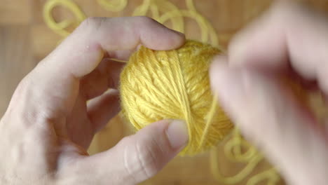 Close-up-of-hand-winding-ball-of-wool