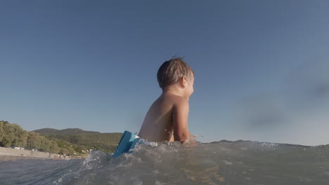 Footage-of-Two-Years-Old-Boy,-Playing-With-Waves-At-Santova-Beach,-Kalamata,-Greece