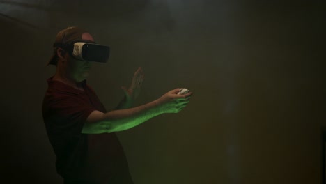 Man-plays-game-while-wearing-VR-headset,-Virtual-Reality-headset