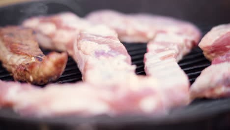 Slow-Motion-Macro-Push-In-of-Meat-Grilling-on-Smoky-BBQ-Grill