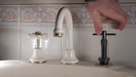 Handyman-reseats-a-household-faucet