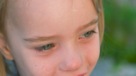 Beautiful-slow-motion-portrait-of-a-smiling,-blue-eyed-little-girl