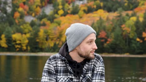 Handsome-Man-on-Gorgeous-Wild-Fall-Lake-contemplates-Life,-Handheld