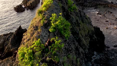 Adventurous-man-free-climbing-on-the-rock-elevated-on-the-sea