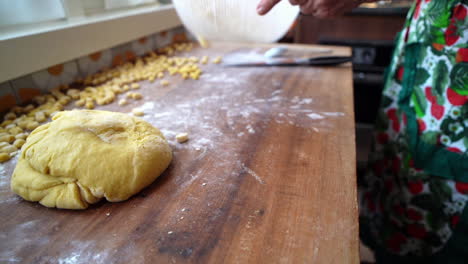 Handmade-preparation-of-struffoli-pastry-on-wooden-board