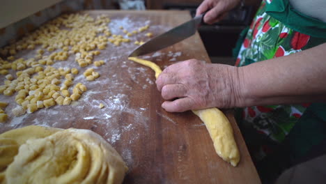 Handmade-preparation-of-struffoli-with-hand-of-woman-cutting-dough