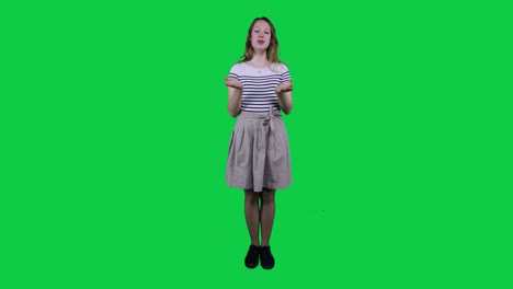 Teenage-girl-singing,-vibing-to-music-in-front-of-a-green-screen