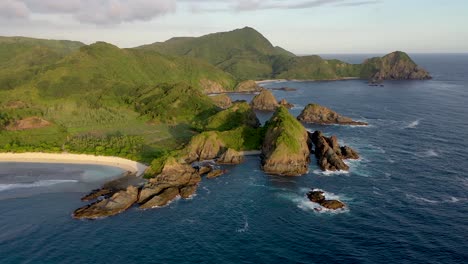 Aerial-panorama-of-the-green-tropical-island-with-cliffs-and-rocky-shore