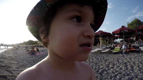 Wide-footage-of-a-boy-playing-ay-the-beach-Kalamata,Greece