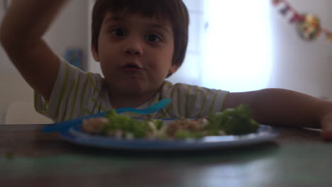 CLOSEUP-Footage-of-a-kid-having-meal-of-Beef-burgers-and-broccoli-at-home