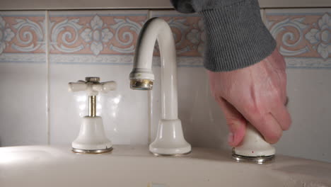 Handyman-replaces-sleeve-of-a-household-bathroom-tap