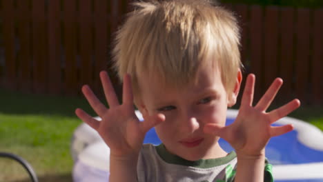 An-adorable-little-blonde-boy-showing-us-his-ten-little-fingers
