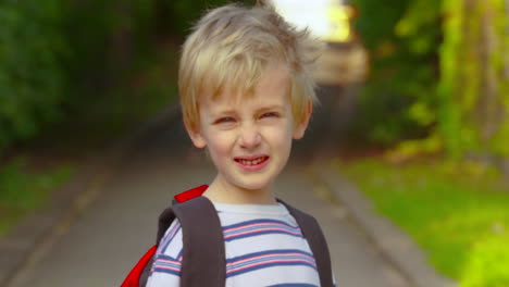Portrait-of-a-cute-little-boy-smiling-before-he-walks-to-school