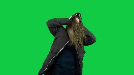 Happy-girl-playing-around-with-the-jacket-in-front-of-the-green-screen
