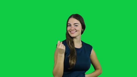 Girl-call-camera-with-one-finger-in-front-of-a-green-screen