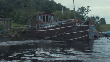 Houseboat-sixty-foot-barge-moored-up-off-shoreline