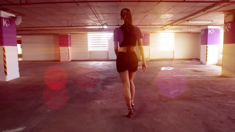 Stunning-,-sexy-model-walking-away-from-the-camera-in-a-parking-garage-with-volumetric-light-streaing-in-the-widows