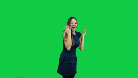 Happy-excited-girl-pointing-promoting-in-front-of-the-green-screen