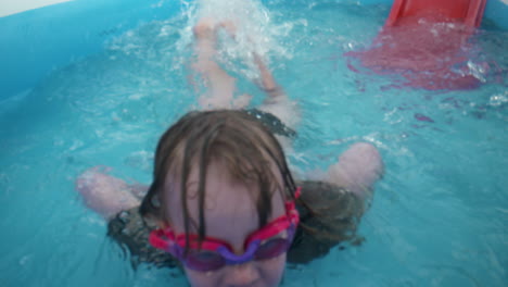 Happy-little-girl-swims-toward-the-camera