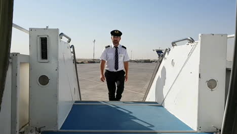 Steward-climbs-steps-of-stairs-to-get-on-board-of-plane
